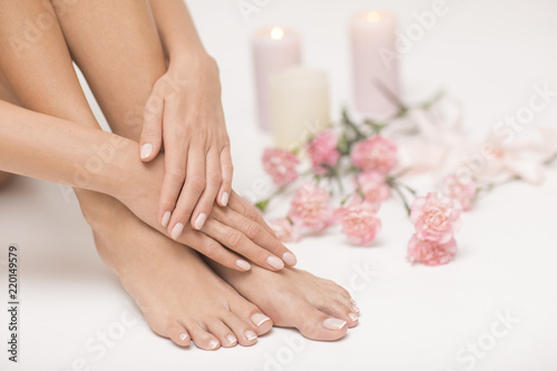 The picture of ideal done manicure and pedicure. Female hands and legs in the spa spot. © forma82