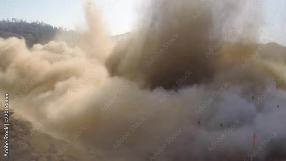 Ground level shot of a dynamite explosion clearing a water channel at the Oroville dam spillway reconstruction project.