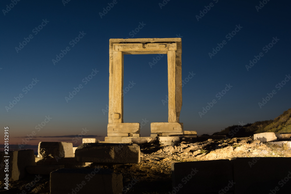 The remains of the ancient temple of Delian Apollo, also called Portara, at dusk, at Naxos island, Greece