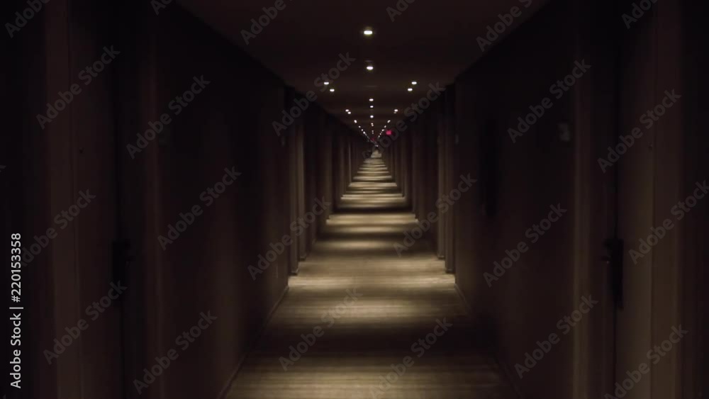 View down a long dark hotel hallway