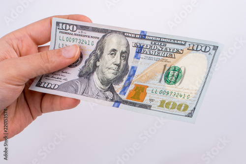 Hands holding American dollar banknotes and Turksh Lira banknotes side by side photo