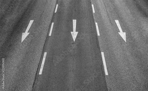 Three arrows on a three lane highway photo