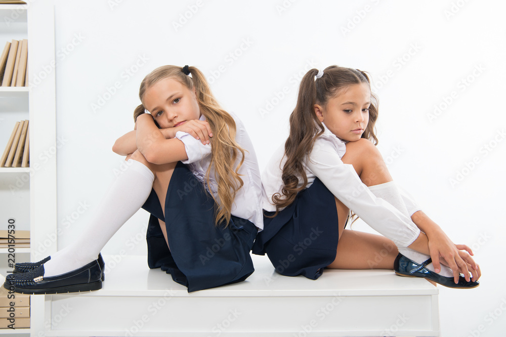 insult. insult of two small girls children or sisters at school. small girls in school uniform. insult. insult of two small girls children or sisters at school. small girls in school uniform.