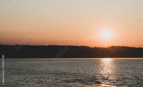 Sunset over a mountain top with water