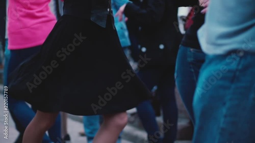 Many people dancing in pairs and having fun at a Latin American open air dance party festival in the street slow motion.