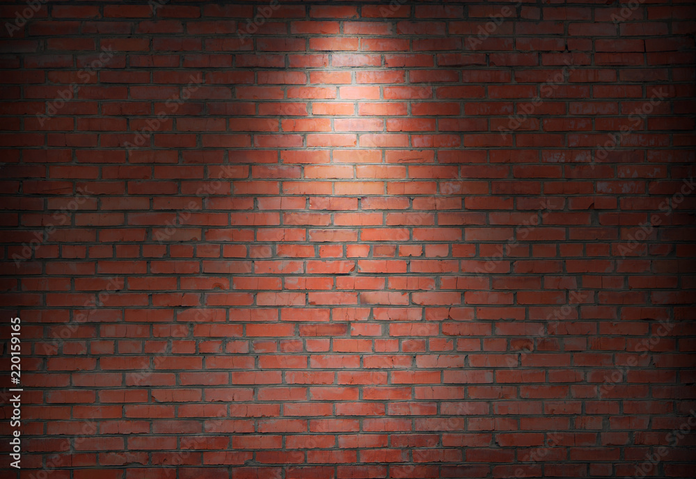 Obraz premium brick wall and spotlight. scene illuminated spotlight. bricks wall background.