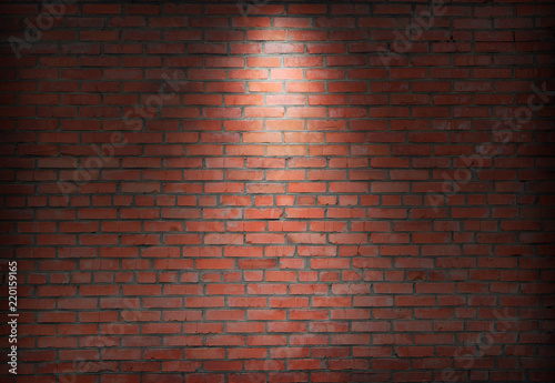 brick wall and spotlight.  scene illuminated spotlight.  bricks wall background. photo