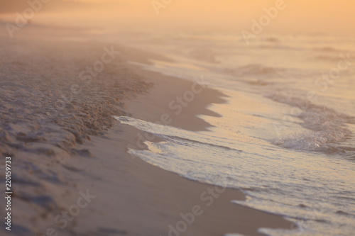 Beach during sunrise fog