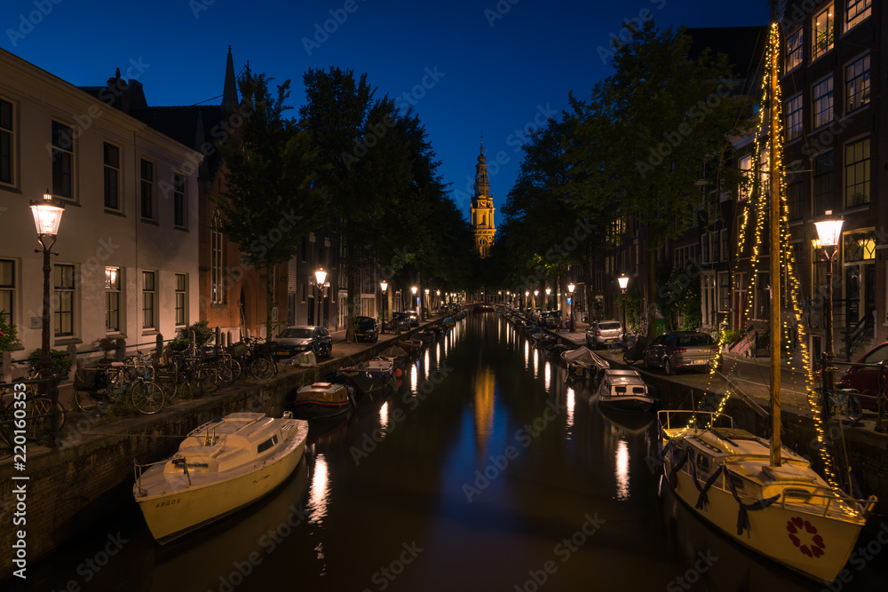 Reflection of the city lights on the canal at night , Amsterdam, the Netherlands.