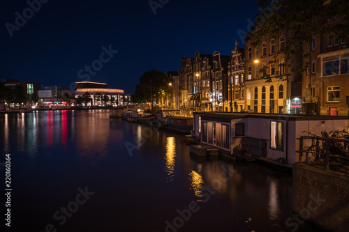 Reflection of the illuminated city of Amsterdam at night   Amsterdam  Netherlands.