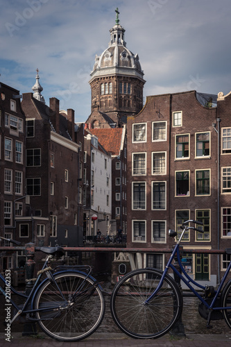 Amsterdam city view with canals, bicycles and typical dutch houses, the Netherlands