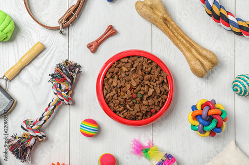 Fototapeta Naklejka Na Ścianę i Meble -  Bowl with food for cat or dog and accessories on wooden background. Pet care