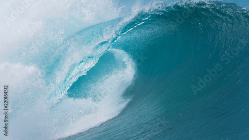 CLOSE UP: Dark blue tube wave rages towards the spectacular coast of Tahiti.