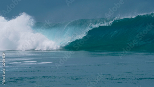 CLOSE UP: Forceful barrel wave splashes ocean water around the coast of Tahiti.