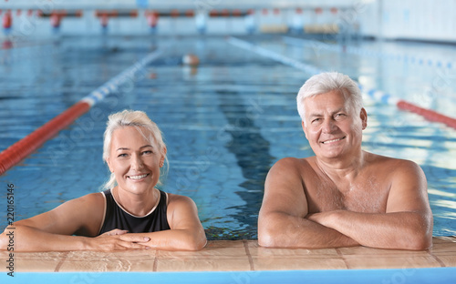 Sportive senior couple in indoor swimming pool