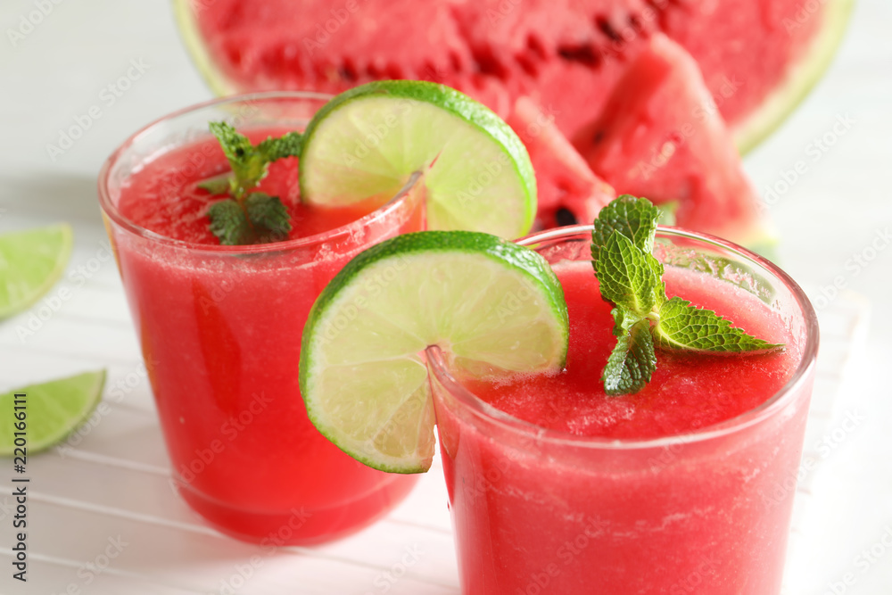 Tasty summer watermelon drink with lime and mint on table, closeup Tasty summer watermelon drink with lime and mint on table, closeup