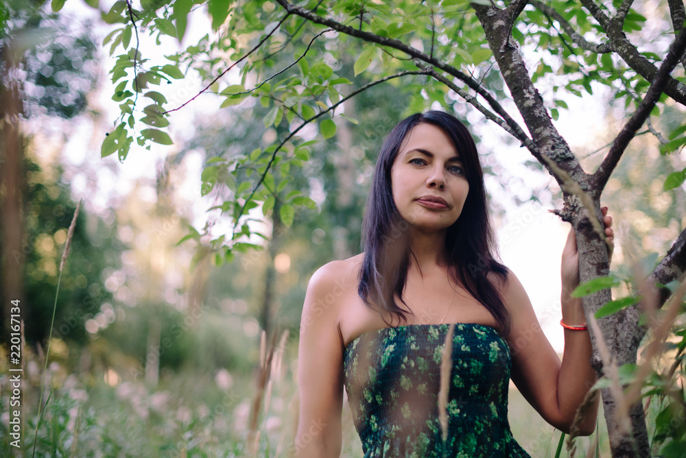 beautiful girl in a long green sundress standing in the field beautiful girl in a long green sundress standing in the field