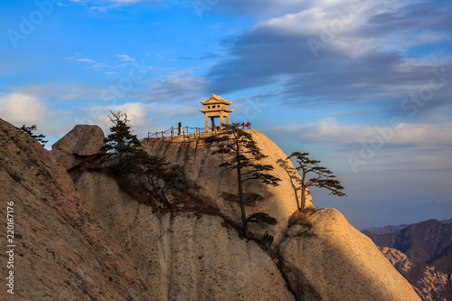 Huashan Sunset, Mount Hua - Huayin, near Xi'an in Shaanxi Province China. Chess Playing Pavilion, Pagoda at the top of a Cliff, Steep Vertical Drop-off, Famous yellow granite mountains of China. 华山 photo