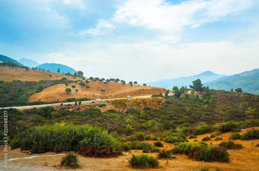 Obraz premium Desert road with Atlas Mountains, Morocco