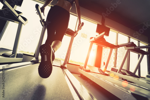 Exercise treadmill cardio running workout at fitness gym of woman taking weight loss with machine aerobic for slim and firm healthy in the morning. photo