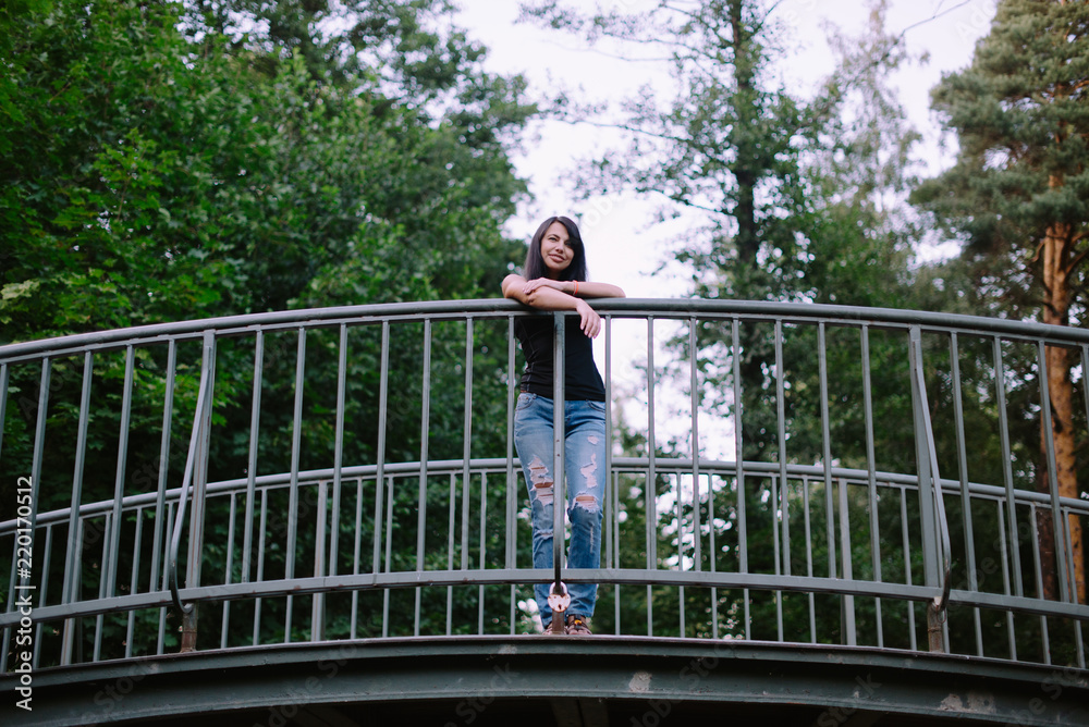 beautiful brunette standing on the bridge