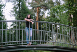 beautiful brunette standing on the bridge