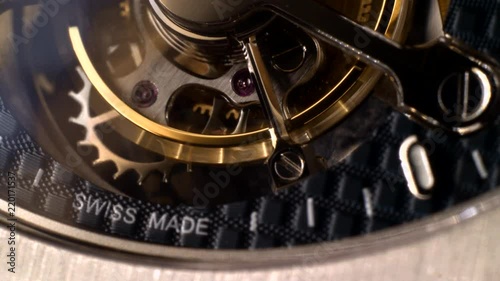 Mechanism of a watch with jewels. Open clockwork and fragments of shiny gears. Close up 4k macro shot. Time and work concept.