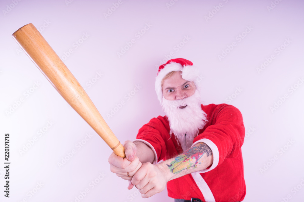 Emotional Santa Claus with a tattoo and a baseball bat on white background.  The concept of an evil Santa Claus. Happy New Year and merry Christmas!  Stock Photo | Adobe Stock