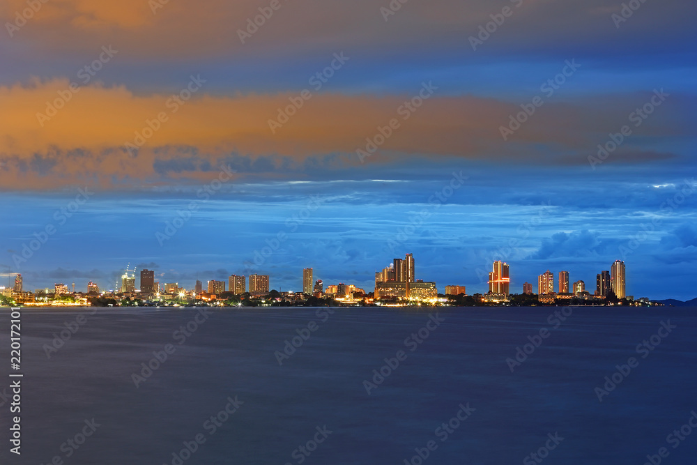 Colorful night lights of pattaya city with sea at night time