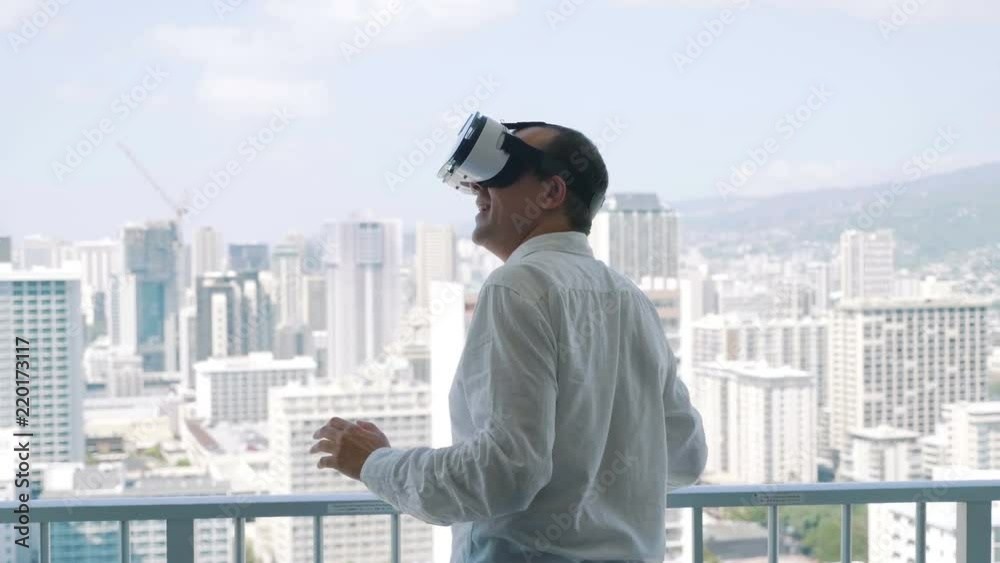 Man playing game in virtual reality glasses in Honolulu in 4k slow motion 60fps Man playing game in virtual reality glasses in Honolulu in 4k slow motion 60fps