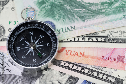 US and China finance economic direction, trade war, import and export or world economy concept, compass on US dollar and china yuan banknotes, tariff deal situation