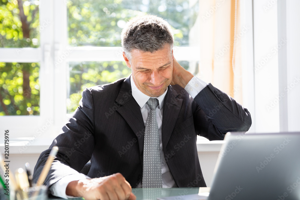 Businessman Suffering From Neck Pain