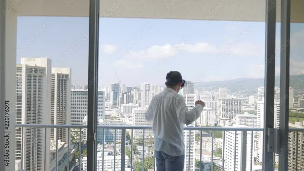 Man playing game in virtual reality glasses in Honolulu in 4k slow motion 60fps Man playing game in virtual reality glasses in Honolulu in 4k slow motion 60fps
