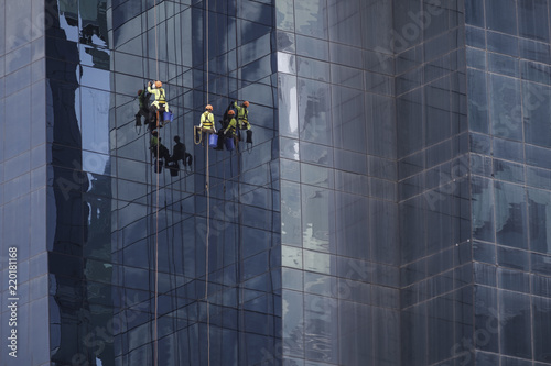 Men at work cleaning the facade of a skyscaper II