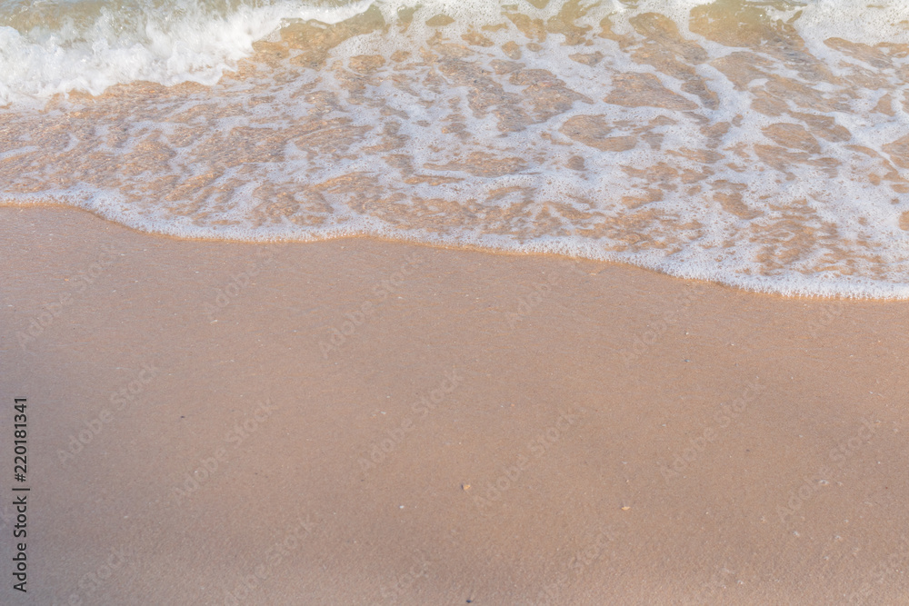 Sea beach foam from surf with light brown sand beach Sea beach foam from surf with light brown sand beach