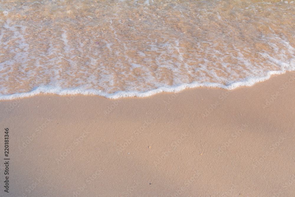 Sea beach foam from surf with light brown sand beach Sea beach foam from surf with light brown sand beach