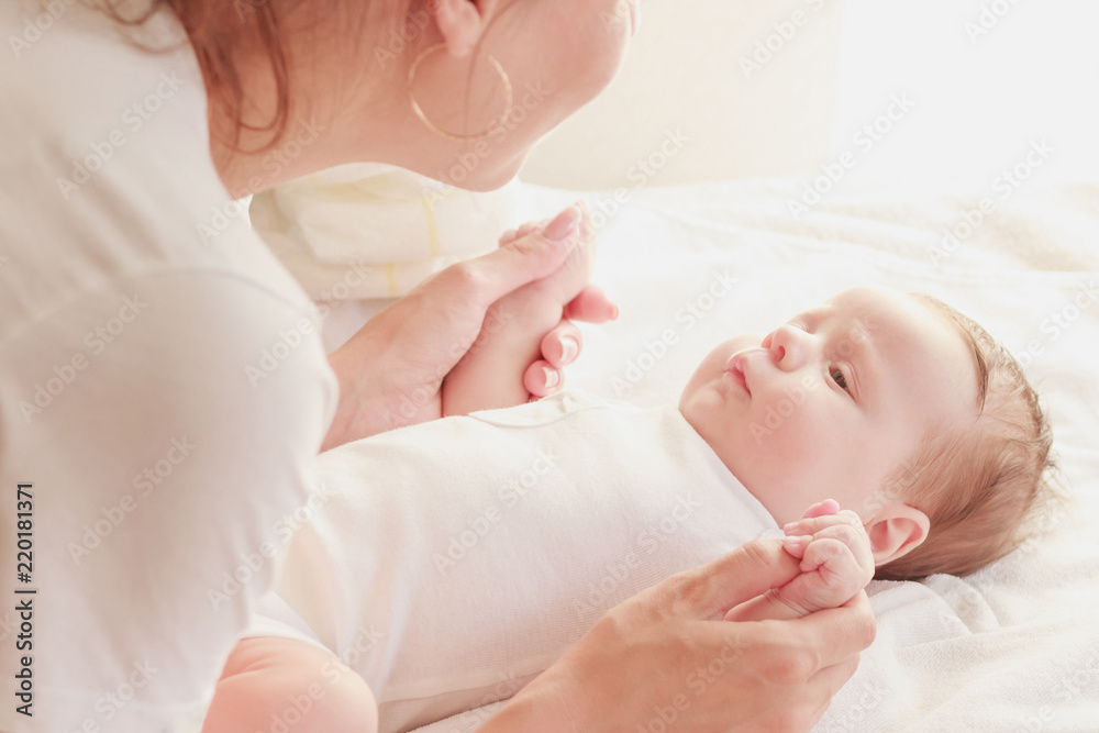 Baby and hands of mother, soft focus background