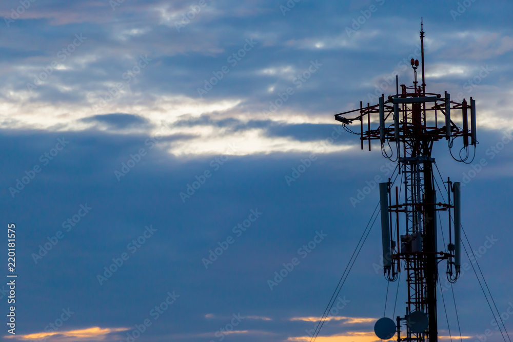 Black silhouette Cellular tower with sky and clouds Black silhouette Cellular tower with sky and clouds
