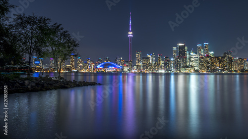 Long exposure of Toronto  Ontario - Canada. Bright sky with a smooth water surface. Beautiful city lights seen from the Toronto Island