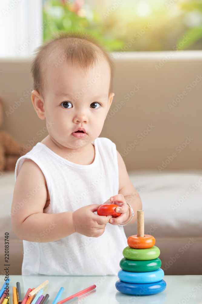 Portrait of adorable little girl playing with toy pyramid Portrait of adorable little girl playing with toy pyramid