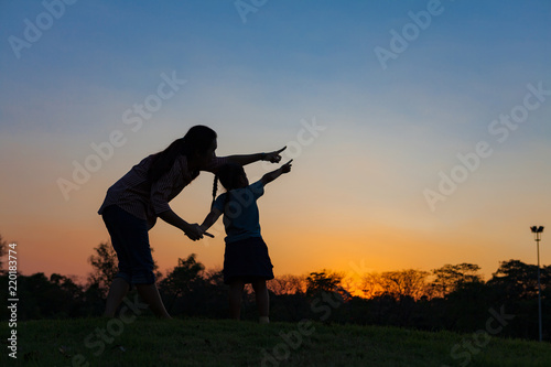 Silhouette healthy and daughter playing together.