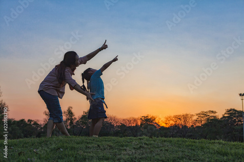 Silhouette healthy and daughter playing together. © Mckyartstudio