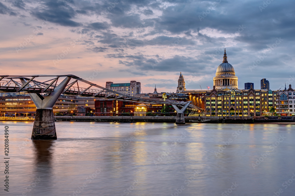 Obraz premium The Millennium Bridge and St. Paul's cathedral in London, UK, at sunset