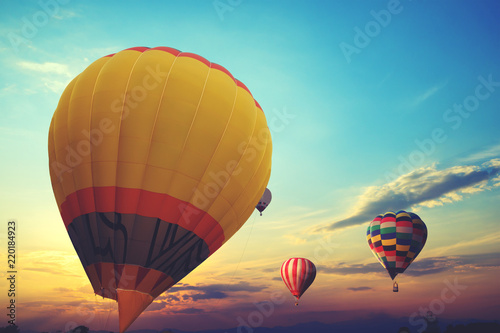 Tablou canvas Colorful hot air balloon flying on sky at sunset