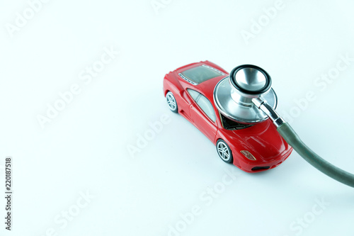 Stethoscope checking up the car on white background, Concept of car check up, repair and maintenance..