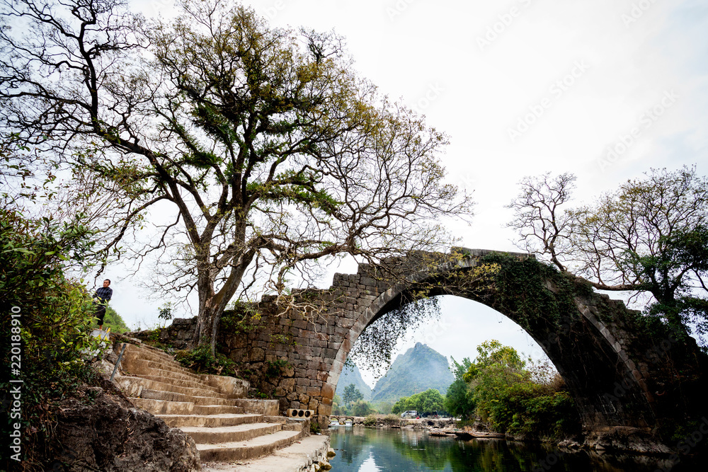 Old bridge on Dragon river in Yangshuo China Old bridge on Dragon river in Yangshuo China