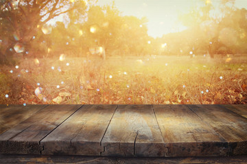 image of front rustic wood boards and background of fall leaves in forest