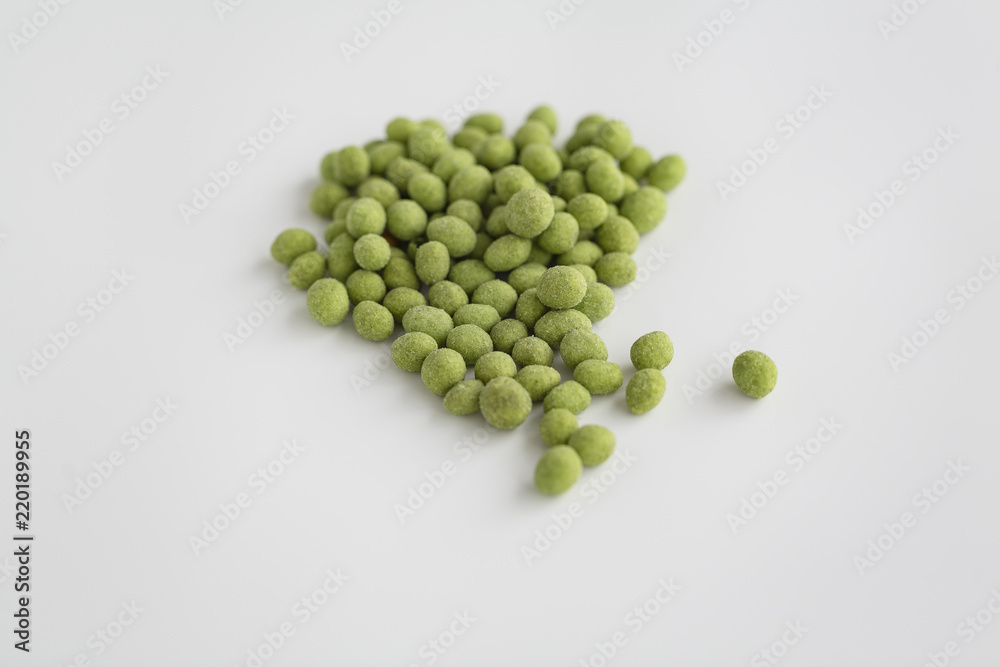 Peanuts coated with wasabi isolated on a white background Peanuts coated with wasabi isolated on a white background