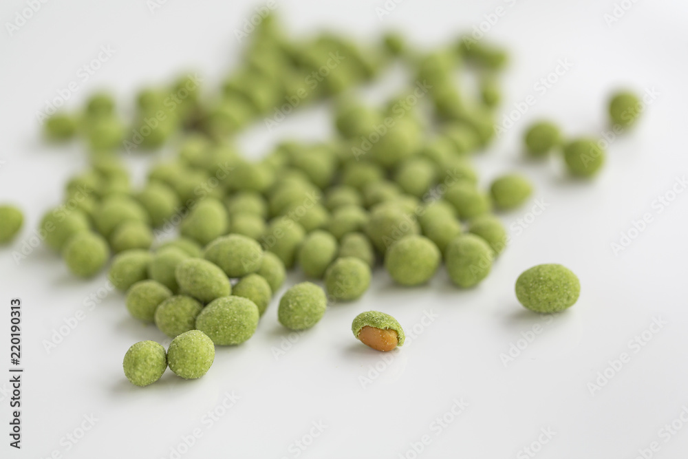 Peanuts coated with wasabi isolated on a white background Peanuts coated with wasabi isolated on a white background