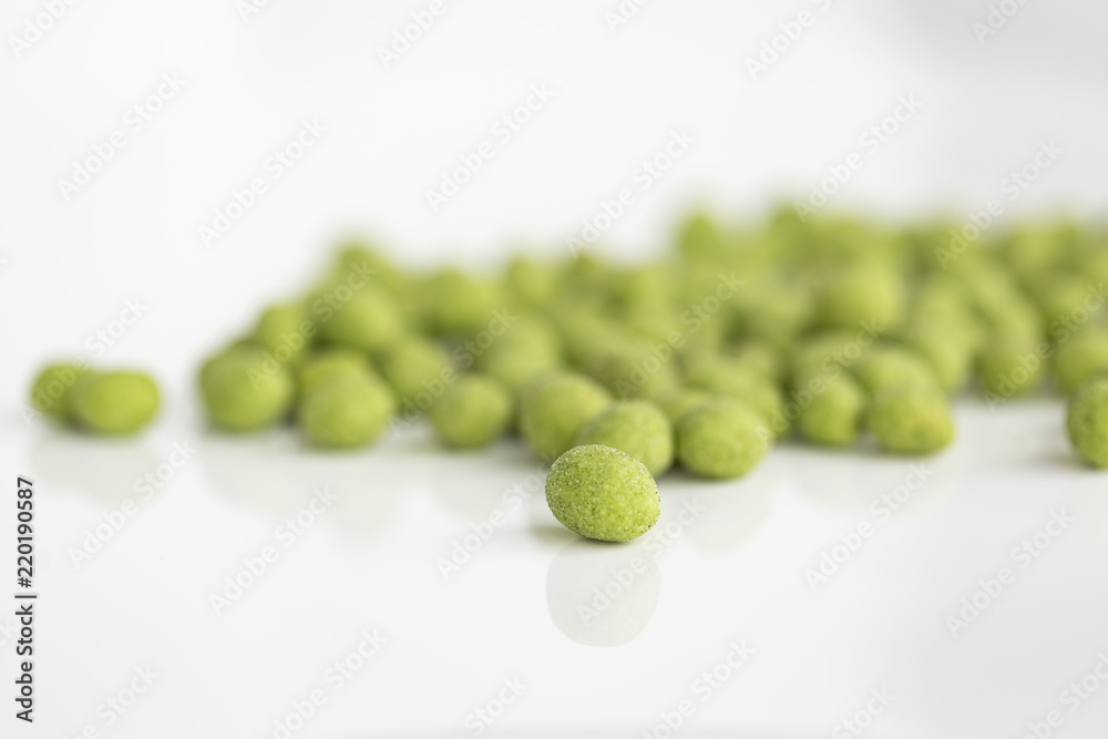 Peanuts coated with wasabi isolated on a white background Peanuts coated with wasabi isolated on a white background